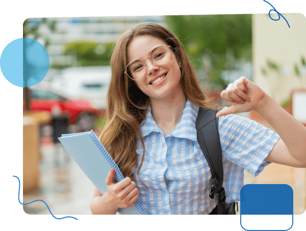 Smiling student holding a smartphone and giving a thumbs-up